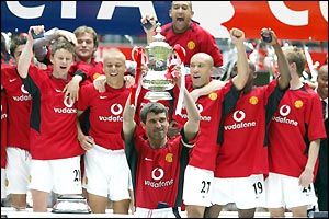 Manchester United captain Roy Keane lifts the FA Cup - surrounded by his delighted team-mates