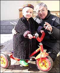 Office driver Alimkhodja Nuritdinov with Monica's son Anvar, aged three