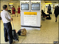 Passenger checking departure monitors at Heathrow