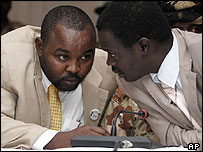 Darfur rebel leader Minni Minnawi talks to a fellow delegate