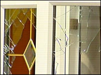 Smashed window in house raided by police