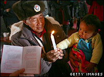 A priest holds a christening for a baby in Yunnan, 2006