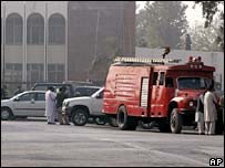 Pakistan's officials and a fire engine at the site of a suicide bombing in Rawalpindi