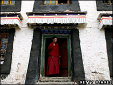 A monk stands in a doorway at Sera monastery in Lhasa on 22 June 2008