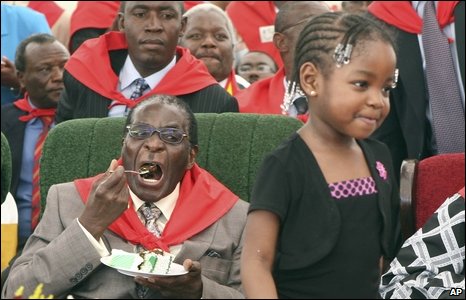 Zimbabwean President Robert Mugabe eats cake at his birthday celebrations