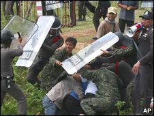 Demonstrators from the People's Alliance for Democracy clash with police and local villagers near Sisaket