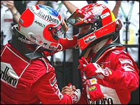 Rubens Barrichello and Michael Schumacher embrace after the race