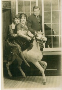 Babe Ruth posing, while first wife Helen and Edna Bancroft on Carousel Horse