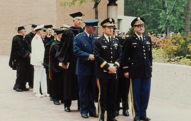 USU’s first Commandant of Students, Army Col. (Dr.) Robert Joy (right), leads the faculty procession for the University’s first Commencement in 1980.  (Uniformed Services University photo)