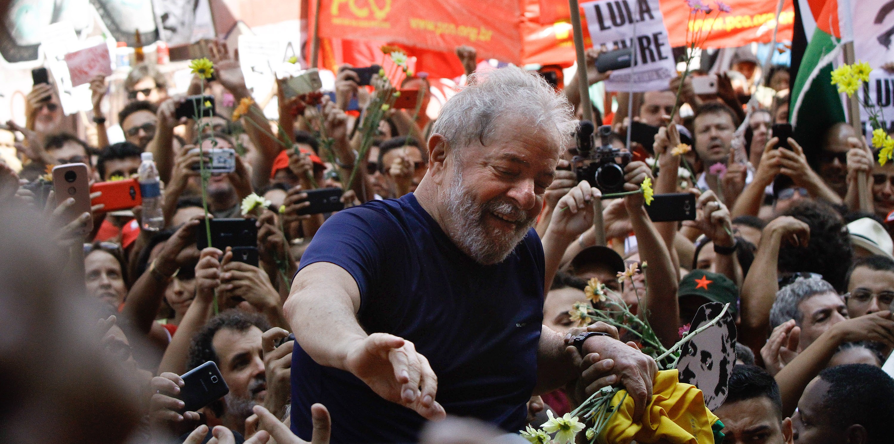 Former President Luiz Inacio Lula da Silva, with impeached former president Dilma Rousseff, gestures to supporters at the headquarters of the Metalworkers' Union where a Catholic mass was held in memory of his late wife Marisa Leticia on April 7, 2018 in the Sao Bernardo do Campo section of Sao Paulo, Brazil. An arrest warrant was issued on Thursday for da Silva to serve a 12-year jail term for corruption. The 72 year old former president told the crowd 'I will comply with their warrant.' (Photo by Fabio Vieira/FotoRua/NurPhoto via Getty Images)