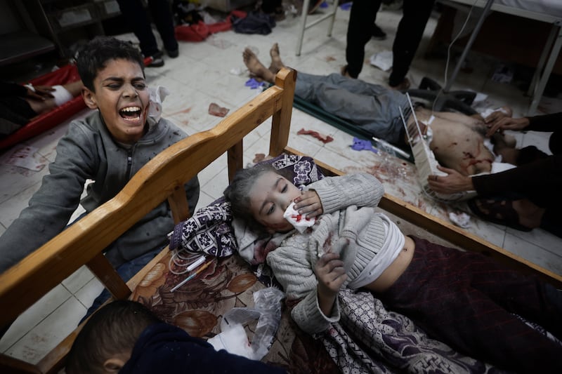Palestinians wounded in the Israeli bombardment of the Gaza Strip arrive at a hospital in Khan Younis on December  8, 2023. AP Photo