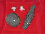 Stone tools of the Developed Olduwan from Cooper's D. Pictured are a hammerstone, an unknown object made of shale, and quartz flake tools