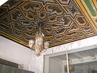Ornate ceiling and lighting fixture at entrance