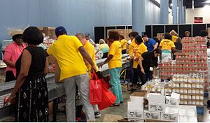 AARP volunteers packing food for older Americans in need at a packing event in Miami.