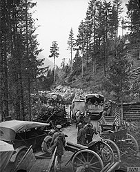 Italian and British troops passing abandoned Austro-Hungarian artillery on the Val d'Assa mountain road, 2 November 1918