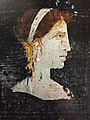 Most likely a posthumous painted portrait of Cleopatra VII of Ptolemaic Egypt with red hair and her distinct facial features, wearing a royal diadem and pearl-studded hairpins, from Roman Herculaneum, mid-1st century AD[40][41]