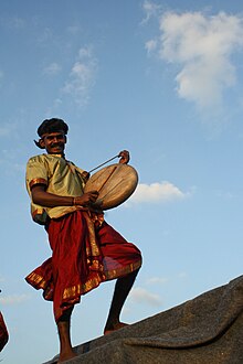 Smiling, costumed man with a drum