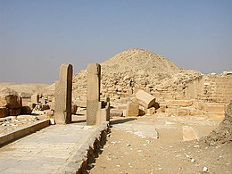 Photograph of a path, two vertical columns and main pyramid.