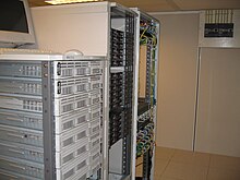 Photo of computer servers. There are 3 racks containing about 10 blade servers each.