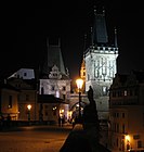 Vista nocturna da torre da Ponte de Carlos situada en Malá Strana.