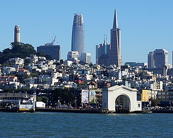 The Salesforce Tower (center-left) and the Transamerica Pyramid (center-right) with Coit Tower (left) and the Pier 43 Ferry Arch (foreground)