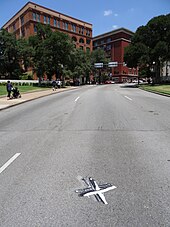 A painted white "X" marks where the spot on Elm Street where the fatal bullet hit Kennedy in Dealey Plaza