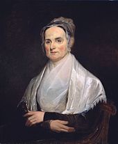 Peinture en buste d'une femme blanche aux cheveux sombres coiffée d'un bonnet, les épaules, le cou et le buste recouverts d'un châle et d'un foulard blanc