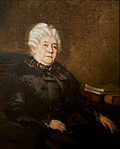 Peinture d'une femme blanche d'âge mûr aux cheveux blancs crantés, en toilette sombre, assise