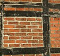 Ordinary brick infill left exposed