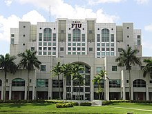An eight-story postmodern tower structure with white and gray cladding. The letters FIU are emblazoned on top.