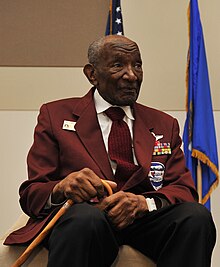 Mosley seated wearing suit jacket with military decorations