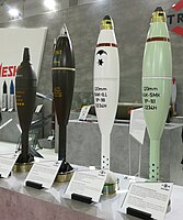 A group of M120 Rak mortar shells. The dark green shells on the left are stencilled to indicate a filling of TNT