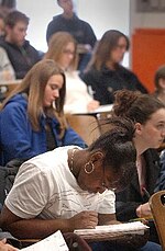 Students taking notes in a classroom