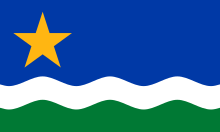 The North Star Flag features of blue over a field of green separated by an undulating white band. A yellow five-pointed star in emblazoned in upper left.
