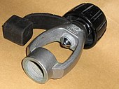 A yoke adaptor shows the DIN socket at one end. The opposite end of the socket piece has the annular ridge for sealing against the O-ring of the cylinder valve, and the yoke with co-axial clamping screw at the far end.