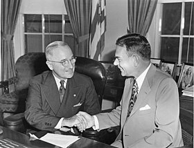 Photograph of Truman with Dewey, sitting on a desk in the Oval Office in 1951
