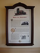 A plaque representing information about a red steam locomotive