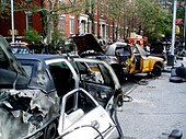 Burnt and abandoned car props are situated near post-apocalyptic Washington Square Park in New York City as part of a set for the film I am Legend.