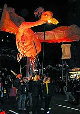 An incandescent baby phoenix conceived and designed by Sophia Michahelles of Superior Concept Monsters rises from fiery ashes to new life in 2001, after the September 11 attacks