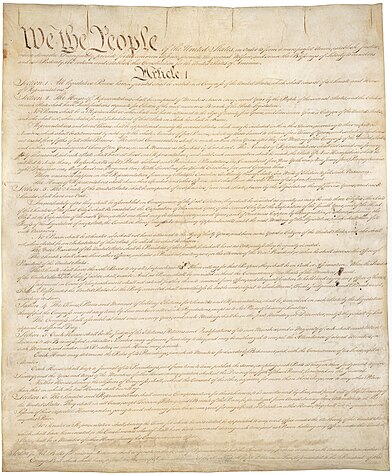 Light-brown parchment with "We the people" in large black cursive