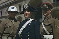 An Italian Carabinieri wearing bicorne (centre), alongside American (left) and British (right) military policemen, 1944.
