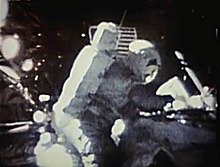 Image taken on the Moon showing an astronaut canceling an envelope (due to the poor quality, the envelope cannot be seen)