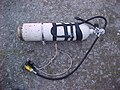 A diving cylinder ready for use on a British cave diving sidemount harness.