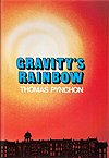 The silhouette of a row of buildings is situated at the bottom of this bright orange cover. "Gravity's Rainbow, Thomas Pynchon" is printed in bold text in the center.