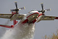 A State Emergency Service Antonov An-32 firefighting aircraft dropping water on a forest fire