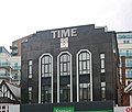 The Time Building on Station Road with a Miller-branded clock - formerly home of Time nightclub in 2000; today part converted into residential use[101]