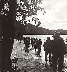 Infantrymen coming ashore from landing craft