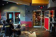 Drums and microphone shown in the tracking room of Avex