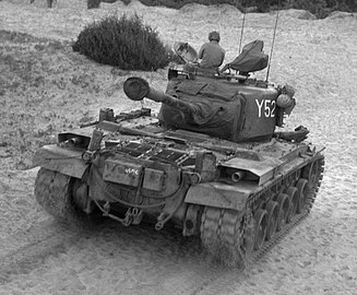 An M46 Patton tank of the United States Marine Corps, in July 1952, during the Korean War. Note the different rear plate and twin fender-mounted exhausts.