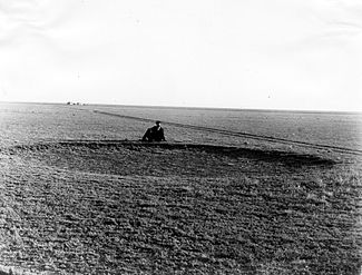 The Great Plains before the native grasses were plowed under, Haskell County, Kansas, 1897, showing a man near a buffalo wallow